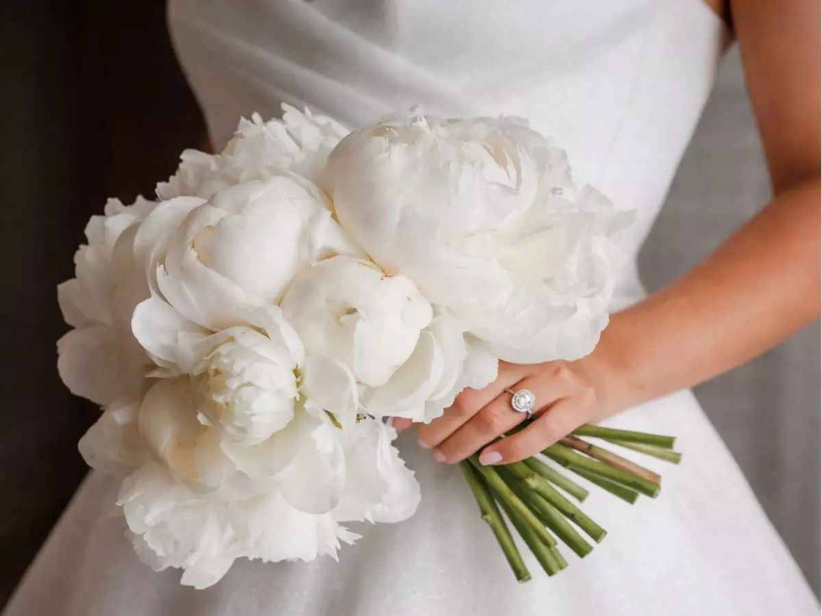 Buquê de noiva clássico com peônias brancas em composição elegante e atemporal.