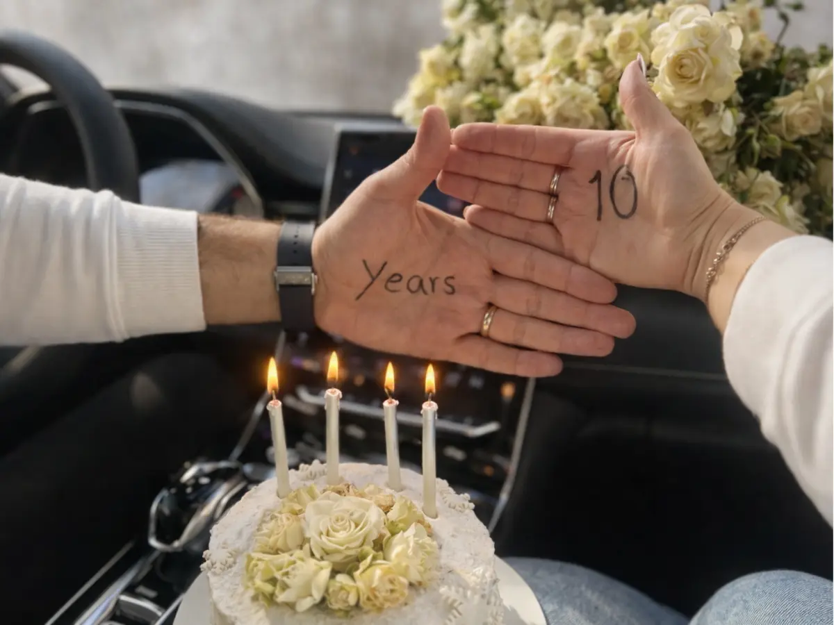 Casal mostrando nas mãos a marca de 10 anos juntos com bolo e velas